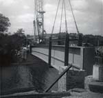 Lowering one side of the bridge into place Lowering one side of the bridge into place