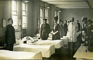 Queen Mary visits soldiers The King and Queen visiting the wounded.
