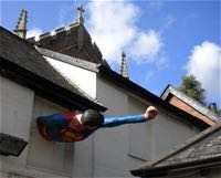 Superman punches out of a rear wall
