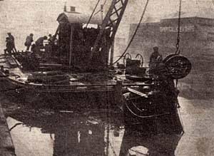 The van being hauled out of the river. The van being hauled out of the river.